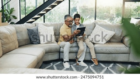 Tablet, search and grandfather with kid on a sofa for gaming, bonding and streaming cartoon video at home. Digital, love and child show senior man how to, app or sign up service choice in living room