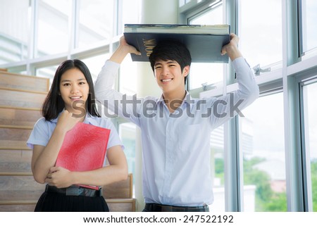 Asia students read a book in Library with uniform Royalty-Free Stock Photo #247522192