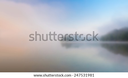 blurry landscape with lake at sunrise useful as background