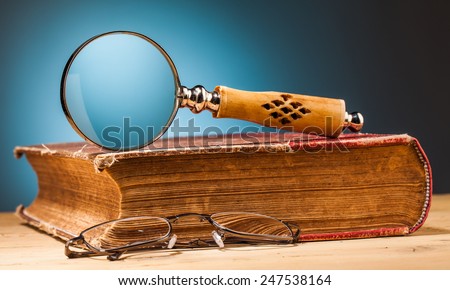 old book on wooden table and blue background