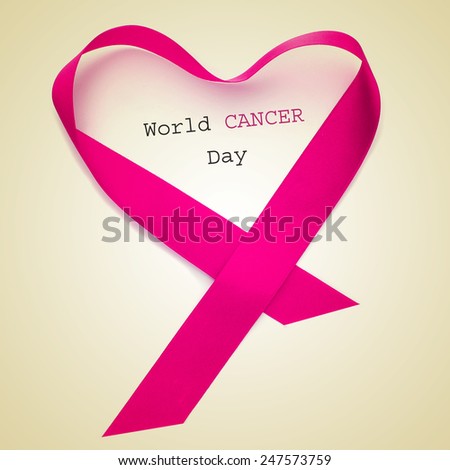 the text world cancer day and a pink ribbon forming a heart on a beige background Royalty-Free Stock Photo #247573759