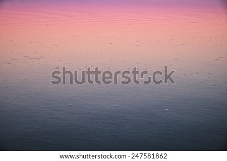Twilight sky effect reflected on a lake calm water surface