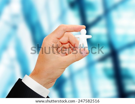 male hand holding a toy man