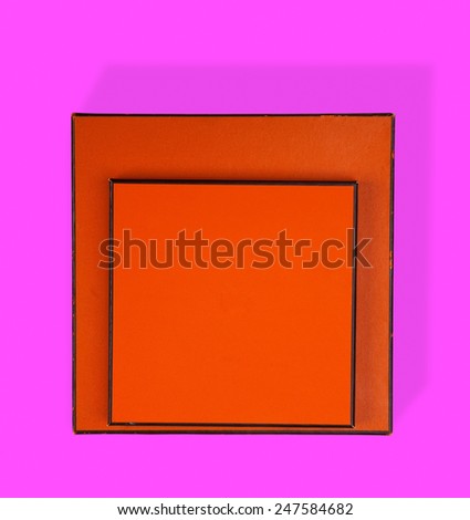Two orange and brown boxes on pink