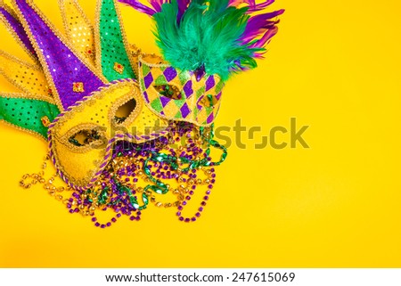 A venetian, mardi gras mask or disguise on a yellow background