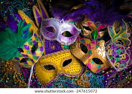 A group of venetian, mardi gras mask or disguise on a dark background Royalty-Free Stock Photo #247615072