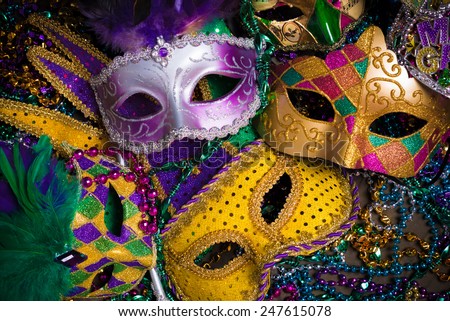A group of venetian, mardi gras mask or disguise on a dark background Royalty-Free Stock Photo #247615078
