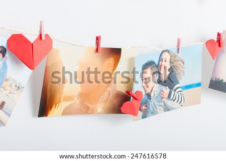 Homemade love decoration. Photos of a couple hanging on clothesline with origami hearts and pin
