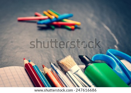 School supplies on black background, vintage color tone