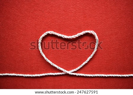 Valentines day card - heart made from wire on red background