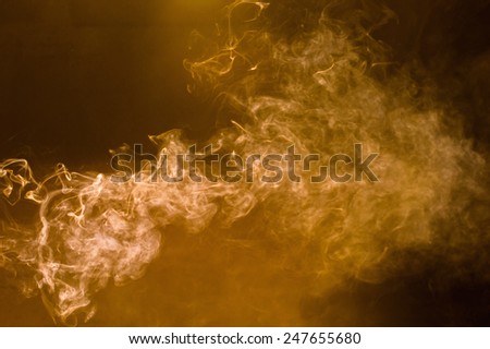 Brown smoke on a black background.