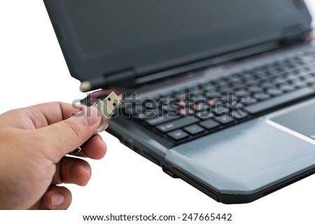 Plugging removable flash disk memory into laptop USB slot