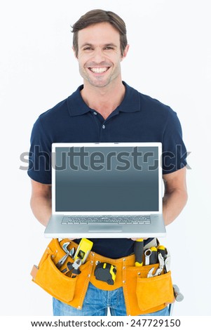 Portrait of happy architect holding laptop over white background