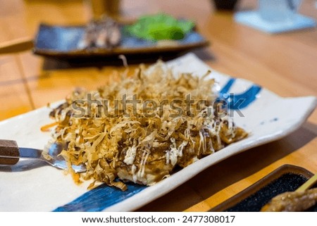 Japanese restaurant with fried noodles Okonomiyaki 