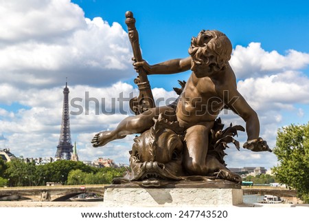 Statue on  the Pont Alexandre III with eiffel tower in background in a beautiful summer day in Paris, France