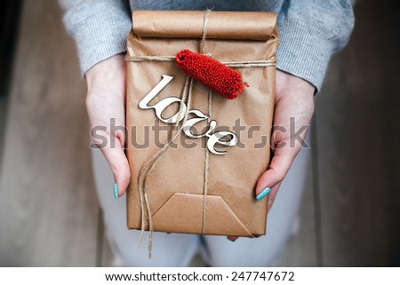 The girl holds in hands charming gift for her loved one