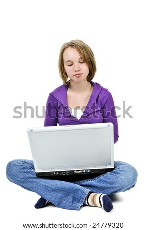 Young girl sitting cross legged with laptop computer