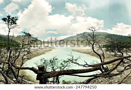 Kawah Putih crater or White Crater of Ciwedey, Bandung, Indonesia and a flock of tourist seen from the barricade pathway of the park. Royalty-Free Stock Photo #247794250