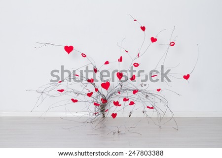 Red hearts hanging on a tree branch. Valentine's Day