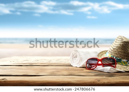white towel on desk and red glasses with hat 
