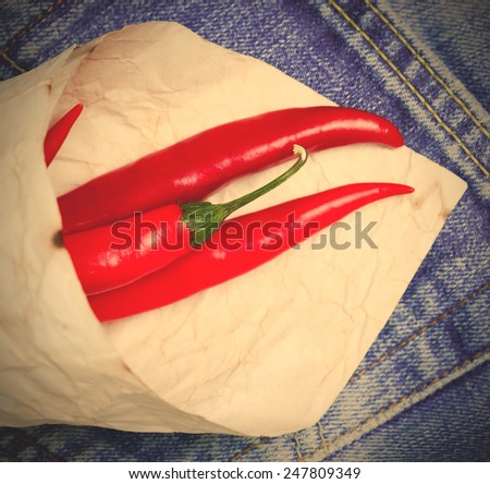 red hot chili peppers in paper bags on a jeans background. instagram image style