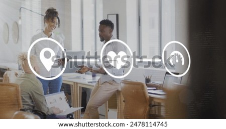 Image of icons connected with lines over diverse coworkers sharing ideas in office. Digital composite, multiple exposure, communication, direction, planning, discussion and teamwork concept.