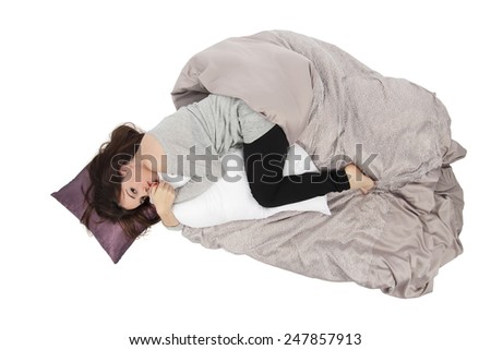 Young woman trying to sleep in a bed against a white background