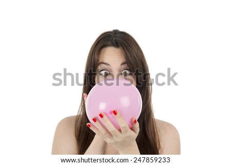 Young woman with a pink bubble gum against a white background