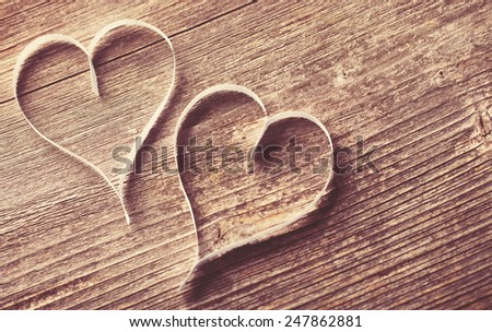 Two paper hearts on wooden background with copyspace