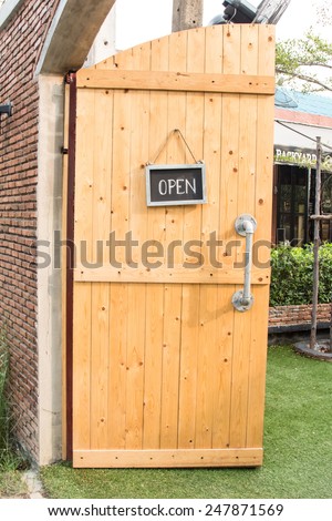 The open sign on a wooden door