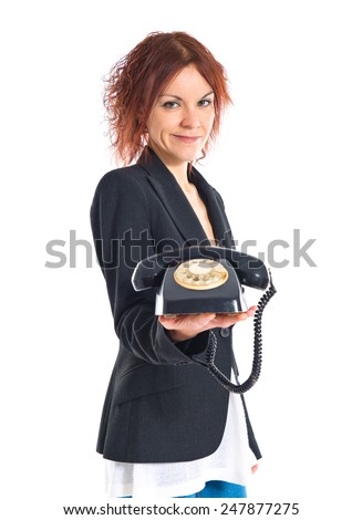 Redhead girl giving vintage phone 