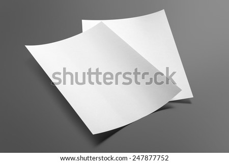 Blank flyer poster isolated on grey to replace your design Royalty-Free Stock Photo #247877752