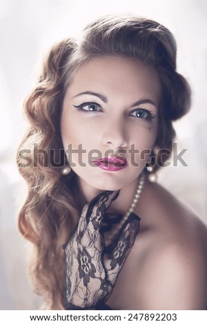 Fashion Brunette Model Portrait. Jewelry and Hairstyle. Elegant lady Isolated on black background.