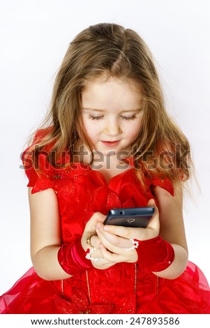 Cute  little ballerina dressed in red  taking a selfie photo isolated on white background