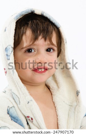 Cute caucasian smiling baby with white bathrobe