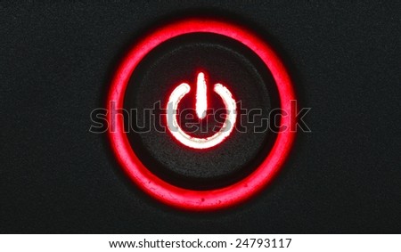 red glowing power button on a black pattern background