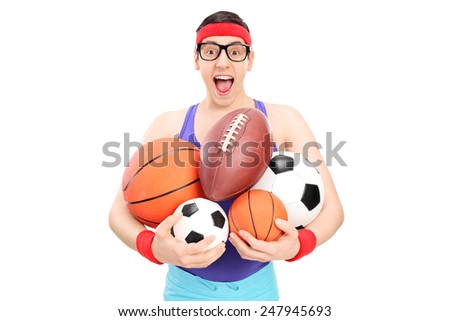 Nerdy guy holding a bunch of sports balls isolated on white background