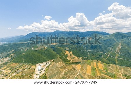 Lamia, Phthiotis, Greece. Panorama of the valley with fields. Olive trees, colorful fields. Summer, Cloudy weather. Aerial view