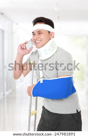 portrait of injured young man talking on the phone