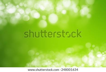 Spring or summer heat abstract nature background with grass in the meadow and sunset with sun beams and bokeh lights in the back