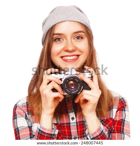 Teenage girl holding a retro film camera