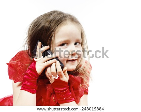 Cute little girl dressed in ball gown playing with smartphone and smiling, isolated on white background