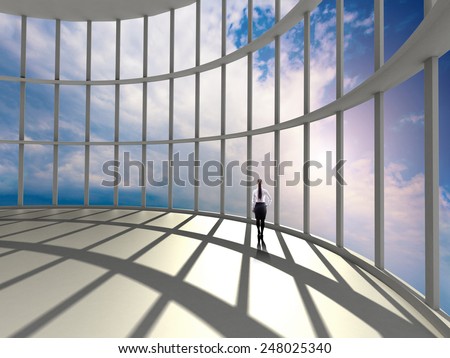 businesswoman standing in office and looking at sky in window