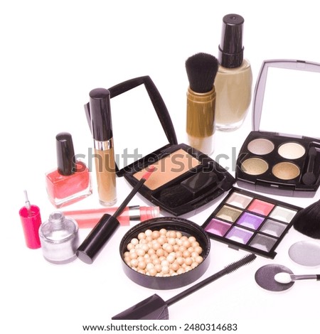 makeup set with nail polish, makeup cream, eye shadows, bronzing pearls, mascara and brush, isolated on white background