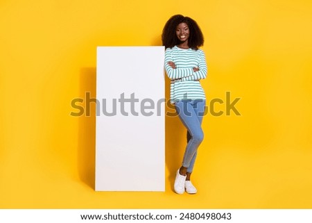 Full size photo of attractive positive lady crossed arms stand near huge empty space phone display isolated on yellow color background