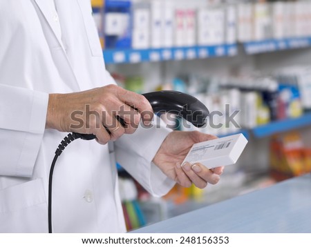 Cropped view of pharmacist scanning medicine with barcode reader Royalty-Free Stock Photo #248156353