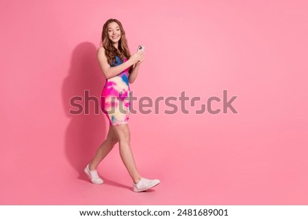 Full length photo of cheerful pretty lady dressed vintage clothes communicating modern gadget empty space isolated pink color background