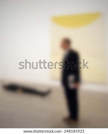 A man visits an art gallery. Intentionally blurred post production.