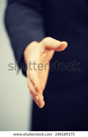 picture of man in suit with an open hand .