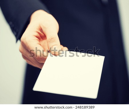picture of man in suit holding credit card